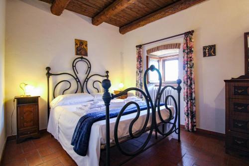 a bedroom with a bed with a wrought iron frame at Santo'S House BnB in Santo Stefano di Sessanio