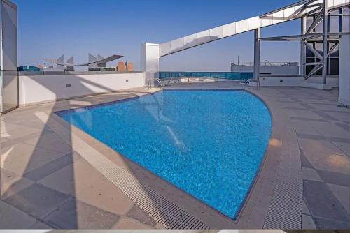 a swimming pool on the roof of a building at BOOK ME! 3 BR Apartment Beach Front (Side View) in Abu Dhabi