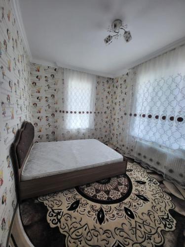 a bedroom with a bed and a rug at A beautiful villa with a swimming pool in the gebele in Gabala