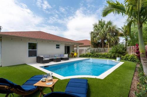a swimming pool in the yard of a house at Modern Comfortable Stay!Sleeps 8! in West Palm Beach