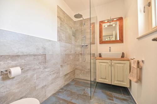 a bathroom with a shower and a sink at Luxury Villa Solea in Barušić