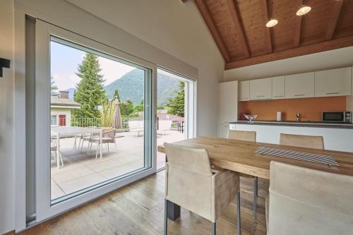 a kitchen with a table and a large window at Terrace Vista Interlaken in Interlaken