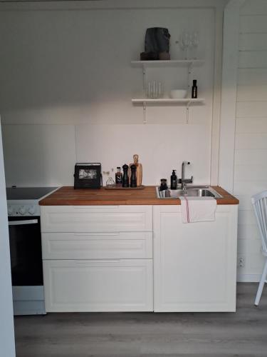 a kitchen with a sink and a counter top at Attefallshuset in Hyllinge