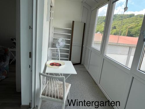 a room with a table and a chair and a window at Hettstein in Idar-Oberstein