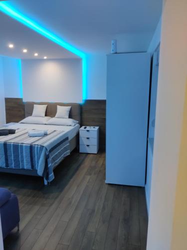 a bedroom with a bed and a blue light at Apartman Amadeus in Gradina