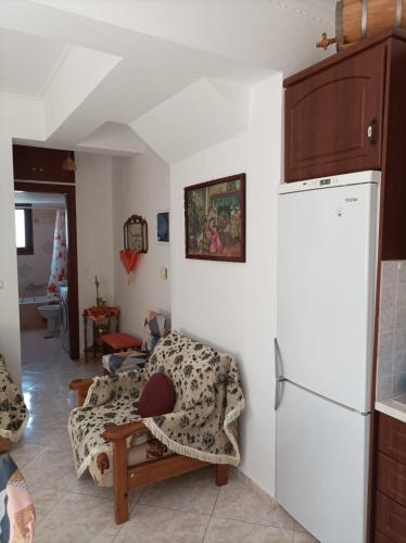 a living room with a couch and a refrigerator at Mountain Voyage Residences in Vatoússa