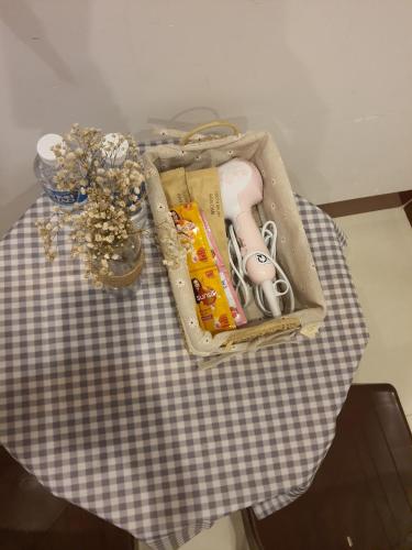 a table with a suitcase on top of a table at Homestay Hoài Tâm Phan Thiết in Phan Thiet