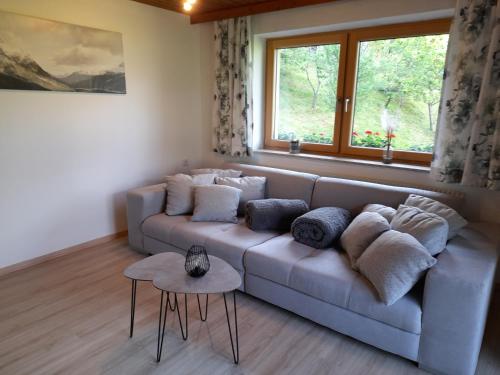 a living room with a couch and a window at Ferienwohnung Rose in Hart im Zillertal