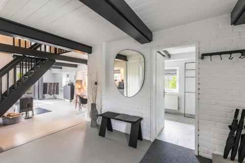 a living room with a bench and a mirror at Loft32 in Nordstrand