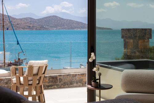 a living room with a view of the ocean at Naiades Boutique Hotel - Adults Only in Elounda