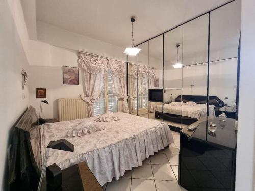 a bedroom with two beds and a large mirror at Heraklion flat , near the aiport in Heraklio