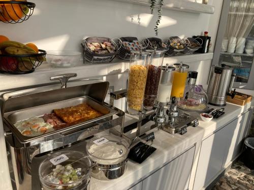 a kitchen counter with a buffet of food at Villa Anemomilos Perissa in Perissa