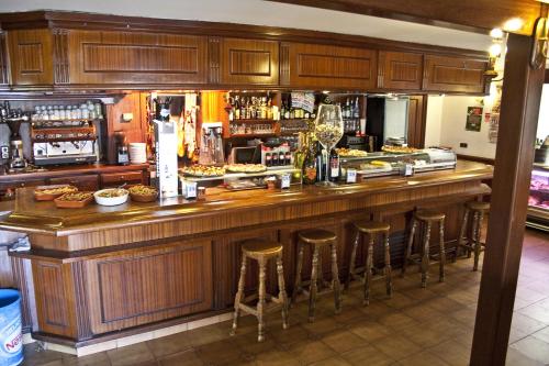 a bar with bar stools in a restaurant at Hostal La Maya in Cercedilla
