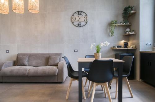 a living room with a table and chairs and a couch at suite 18 luxury apartments in Bari