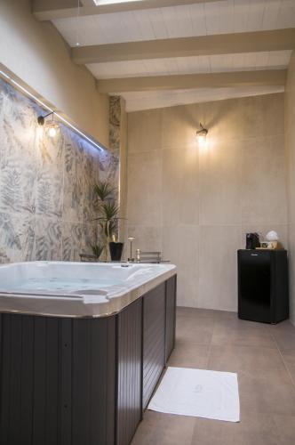 a bathroom with a large tub and a sink at suite 18 luxury apartments in Bari