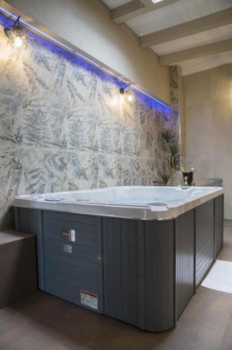 a large bath tub in a room with a wall at suite 18 luxury apartments in Bari