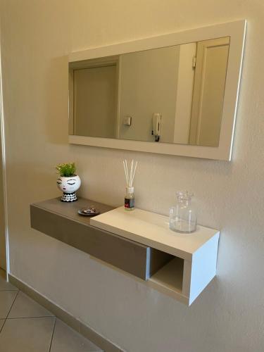 a bathroom with a sink and a mirror on a wall at Rondi-Home in Empoli