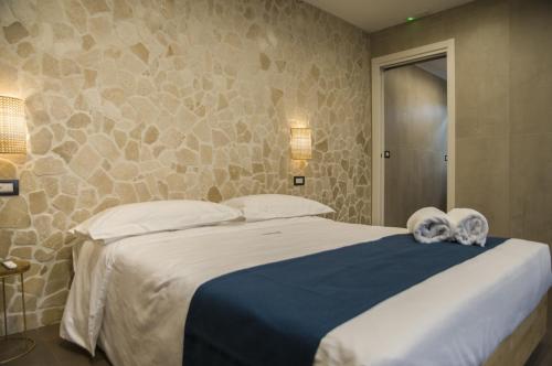 a bedroom with a large bed with towels on it at suite 18 luxury apartments in Bari