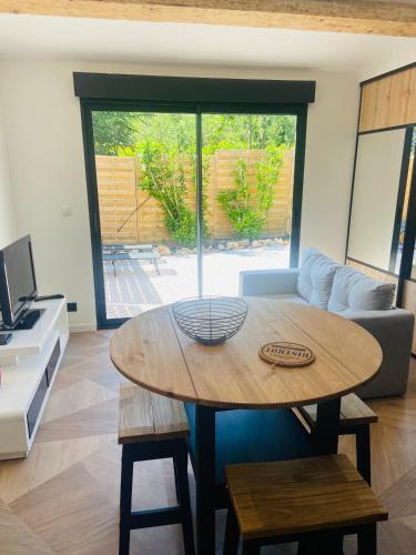 a living room with a table and a couch at Cosy Lodge Sainte Baume in Nans-les-Pins