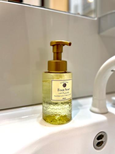 a bottle of soap sitting on top of a sink at Le Studio 五条高倉 in Kyoto
