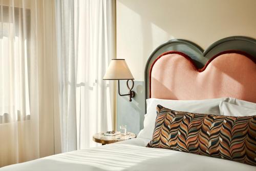 a bedroom with a bed with a large heart headboard at The Hoxton, Charlottenburg in Berlin