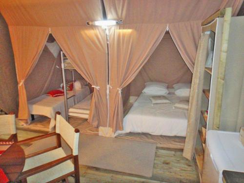 a bedroom with a bed in a tent at Le Village Vacances de Mimizan Plage in Mimizan-Plage