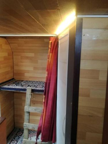 a small room with two bunk beds and a ladder at Karavan in Kucukkuyu