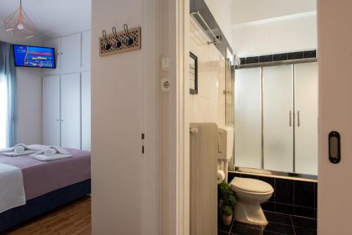 een badkamer met een bed en een toilet in een kamer bij Blue Ark Wanderlust in Athene