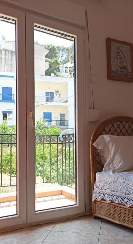 a room with a sliding door to a balcony at NEFELI VILLA in Patitiri
