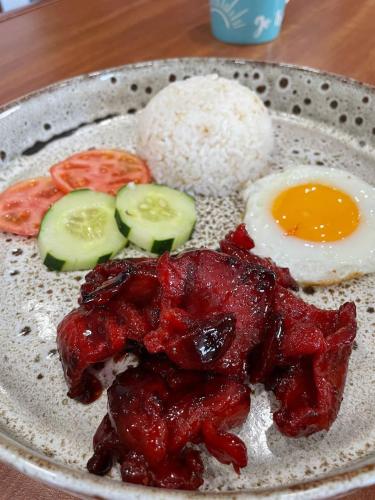 a plate of food with eggs and tomatoes and rice at Paragon Hotel and Suites in Baguio