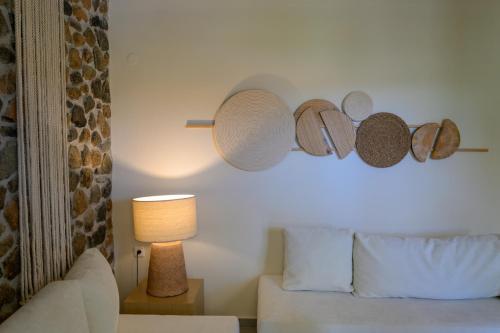 a room with a bed and a lamp and a couch at Oikies Small Elegant Houses in Mytilini