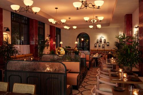 a restaurant with tables and chairs in a room at The Hoxton, Charlottenburg in Berlin