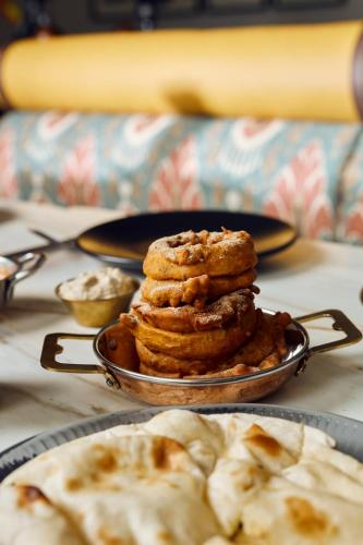 a stack of cookies on a plate on a table at The Hoxton, Charlottenburg in Berlin