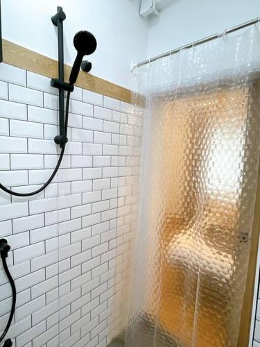 a shower with a shower curtain in a bathroom at Unwind in oldtown, private floor, near Grand Palace in Bangkok