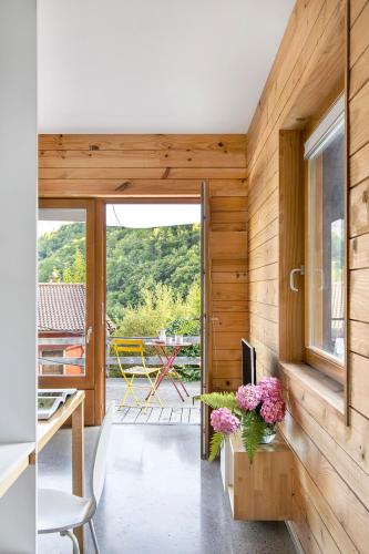 a room with wooden walls and a table with flowers on it at Centro de Ecoturismo Tierra del Agua in Caleao