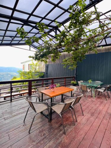 a patio with tables and chairs on a deck at Yun pu cha jan in Fanlu