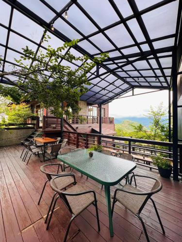 a patio with a table and chairs on a deck at Yun pu cha jan in Fanlu