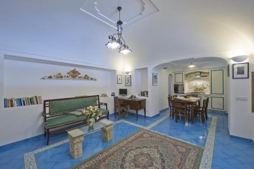 a living room with a couch and a table at Villa Il Frantoio and Lilmar in Praiano