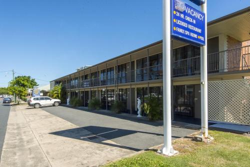 a building with a blue sign in front of it at Mid City Motor Inn in Mackay