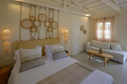 a living room with two beds and a couch at Oikies Small Elegant Houses in Mytilini