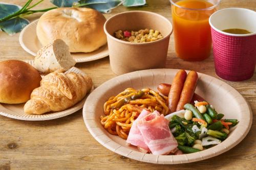a wooden table with plates of food and drinks at Shinagawa Prince Hotel N Tower in Tokyo