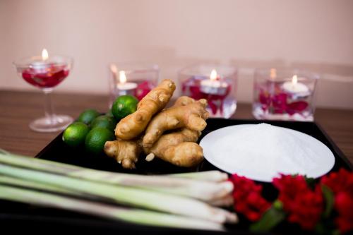 a tray of vegetables on a table with candles at Muong Thanh Luxury Ha Nam in Phủ Lý
