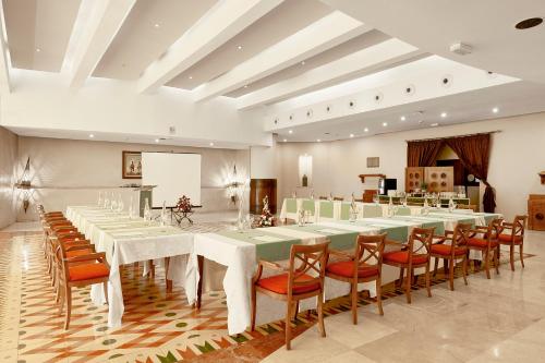 a large banquet hall with white tables and chairs at Iberostar Waves Founty Beach All Inclusive in Agadir