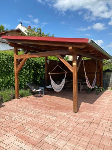 a wooden pavilion with a hammock under it at Penzion Labská Vyhlídka in Litoměřice