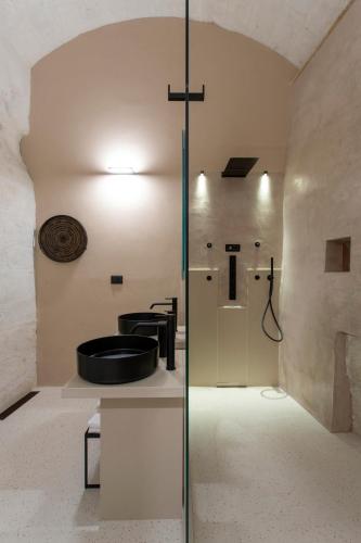 a bathroom with a sink and a glass shower at PIANELLE RESORT in Matera
