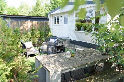 a backyard with a wooden table and a house at Nature hideout at Veluwe nature park in Putten