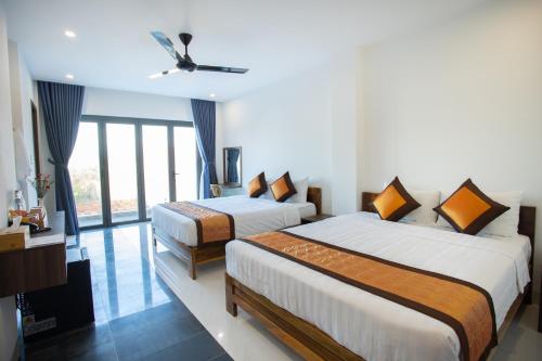 Katil atau katil-katil dalam bilik di Palm Beach Hotel Phu Yen - Kite surfing spot in winter