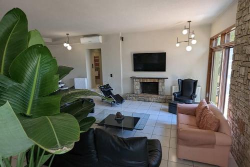 a living room with a couch and a fireplace at Villa Khaki in Fíkhtion
