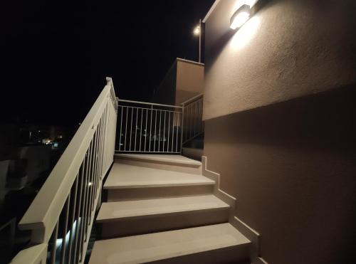 a stairway at night with a light on the side of a building at DolceVita Home in Civitanova Marche