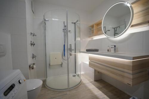 a bathroom with a shower and a toilet and a mirror at Seeblick - a57219 in Cuxhaven